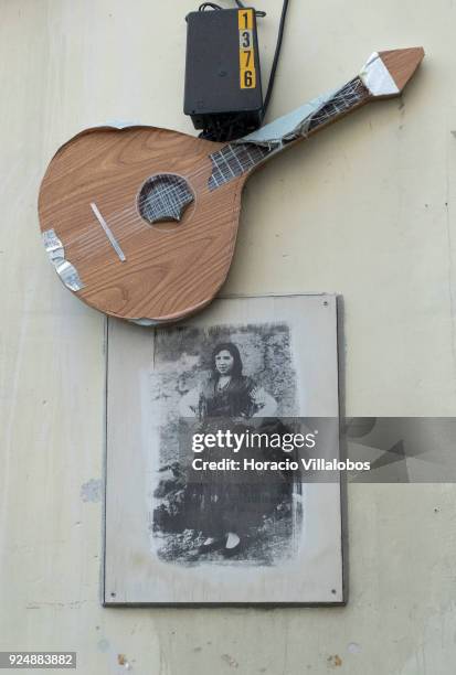 The old picture of a Fado singer, part of "Retratos de Fado" exhibit, hangs under the recreation of a Portuguese guitar in Mouraria neighborhood on...