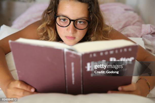 Girl reading Harry Potter.