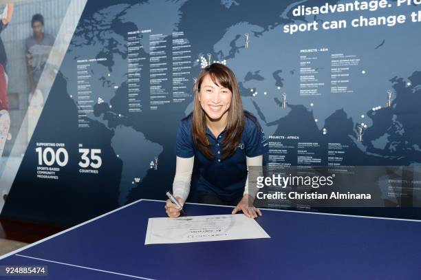 Tennis player and New Laureus Ambassador Ai Sugiyama signs her certificate prior to the Laureus World Sports Awards at the Meridien Beach Plaza on...