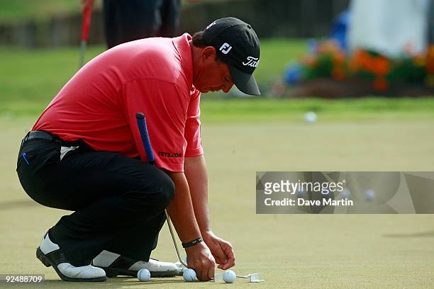 Tom Pernice Jr., sets up a putting aide after first round play was postponed in the Viking Classic at the Annandale Golf Club on October 29, 2009 in...