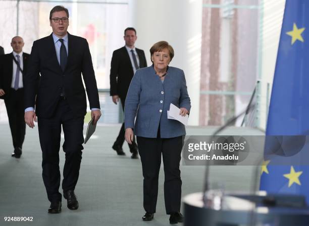German Chancellor Angela Merkel and Serbian President Aleksandar Vucic arrive to hold a joint press conference following their meeting in Berlin,...