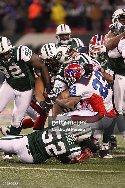 Linebacker David Harris and safety Jim Leonhard of the New York Jets make a stop of running back Marshawn Lynch of the Buffalo Bills at Giants...