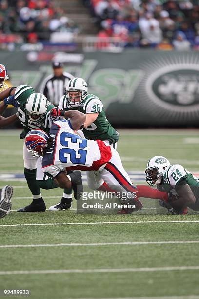 Safety Kerry Rhodes, cornerback Darrelle Revis and safety Jim Leonhard of the New York Jets make a stop of running back Marshawn Lynch of the Buffalo...