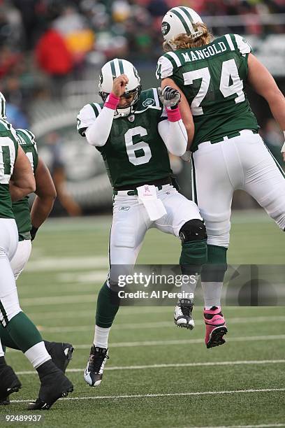 Quarterback Mark Sanchez of the New York Jets celebrates a touchdown with center Nick Mangold against the Buffalo Bills at Giants Stadium on October...