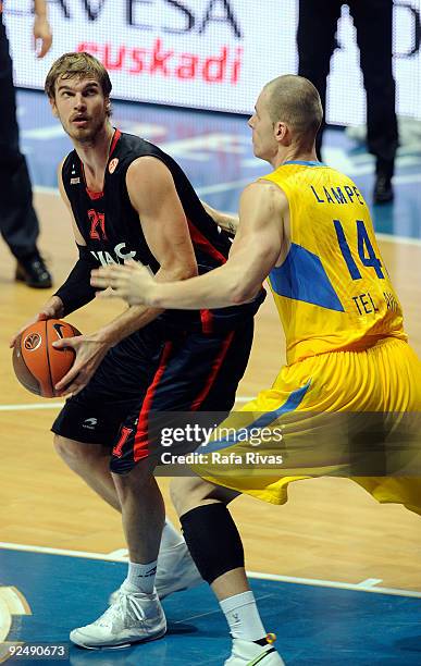 Tiago Splitter, #21 of Caja Laboral competes with Maciej Lampe, #14 of Maccabi Electra during the Euroleague Basketball Regular Season 2009-2010 Game...