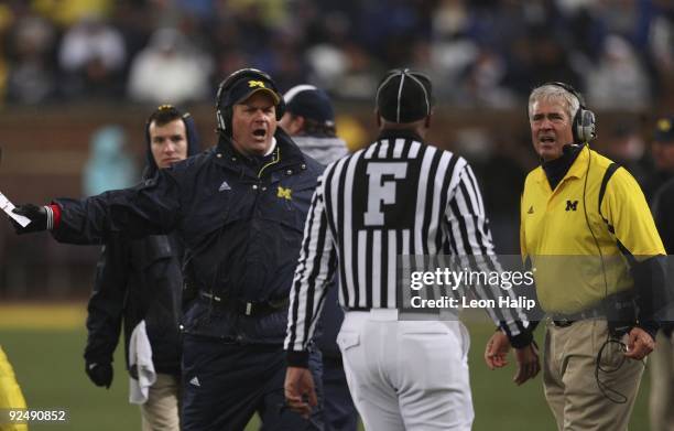 Head Coach Rich Rodriguez and Defensive Coordinator Greg Robinson of the University of Michigan react to a call made late in the third quarter during...