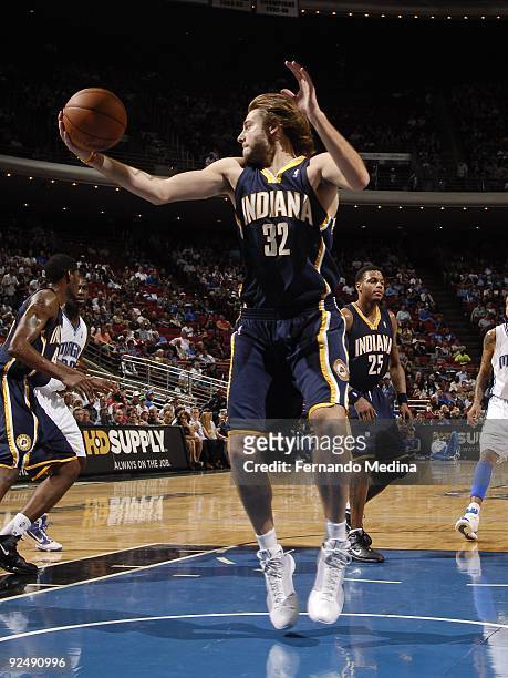 Josh McRoberts of the Indiana Pacers grabs a rebound against the Orlando Magic during a pre-season game on October 21, 2009 at Amway Arena in...