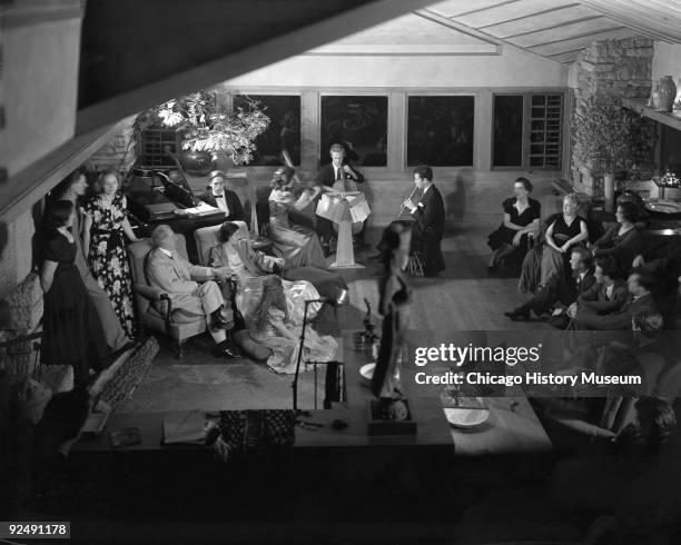 The architect Frank Lloyd Wright enjoys a musical performance with members of his family and the Taliesin Fellowship at Taliesin East in Spring...