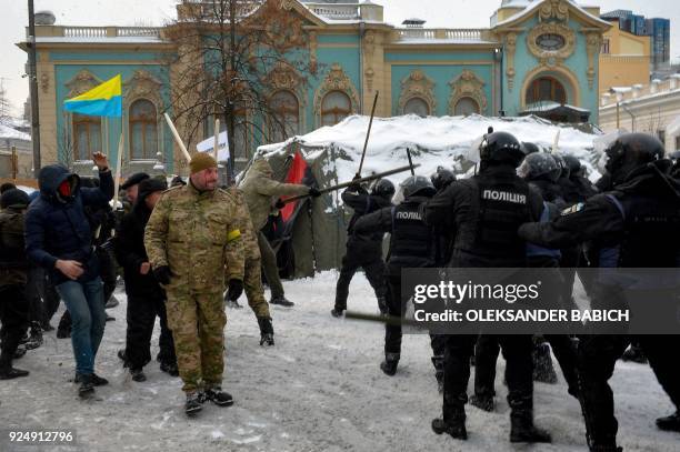 Policemen clash with supporters of former Georgian President Mikhael Saakashvili based in a tent camp in front of the Ukrainian parliament on...