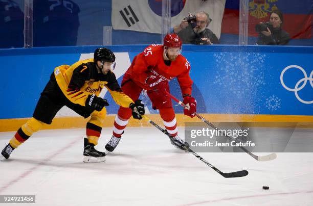 Daryl Boyle of Germany, Mikhail Grigorenko of Olympic Athlete from Russia during the Men's Ice Hockey Gold Medal match between Germany and Olympic...
