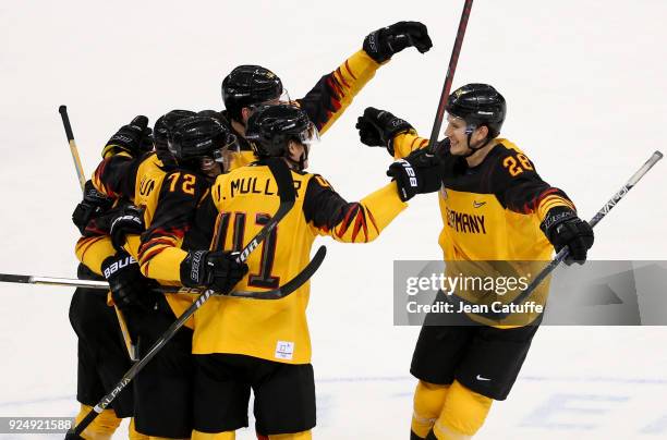 Dominik Kahun of Germany celebrates his goal with teammates and Frank Mauer during the Men's Ice Hockey Gold Medal match between Germany and Olympic...