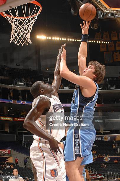 Kyrylo Fesenko of the Utah Jazz puts up a shot over DeSagana Diop of the Charlotte Bobcats during the preseason game at Staples Center on October 18,...