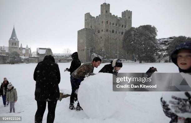 Children roll snowmen in the Castle grounds on February 27, 2018 in Rochester, United Kingdom. Freezing weather conditions dubbed the 'Beast from the...