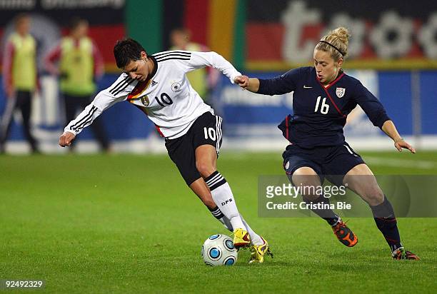 Linda Bresonik of Germany and Ella Masar of USA battle for the ball during the Women's International friendly match between Germany and USA at the...