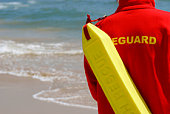 Baywatch Lifeguard With Float At A Beach