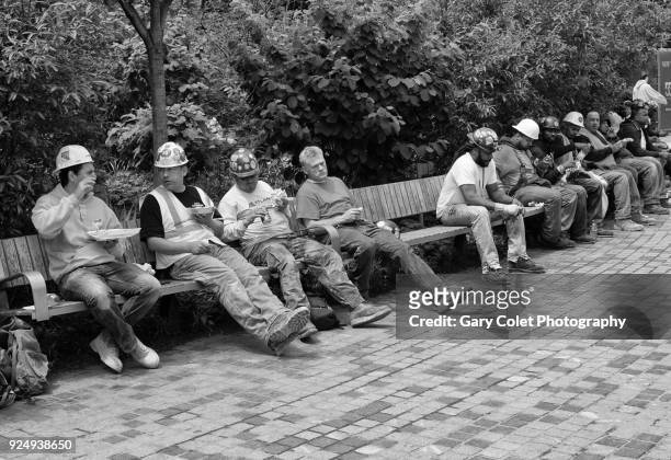 new york construction workers relaxing on benches eating lunch - gary colet - fotografias e filmes do acervo