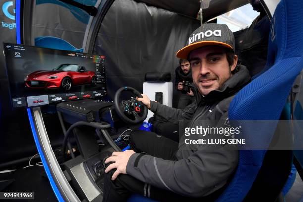 McLaren's Spanish driver Fernando Alonso sits at the Logitech virtual reality simulator at the Mobile World Congress , the world's biggest mobile...