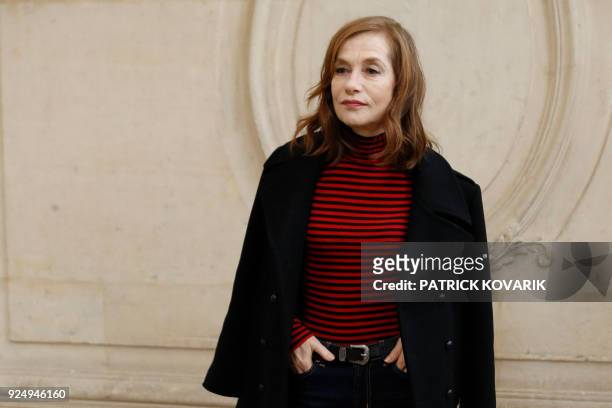 French actress Isabelle Huppert poses for a photo-call before the Christian Dior's 2018/2019 fall/winter collection fashion show on February 27, 2018...