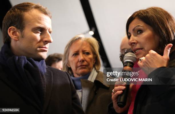 French president Emmanuel Macron and French Junior Minister in charge of Disabled People Sophie Cluzel look on as Paris mayor Anne Hidalgo speaks...