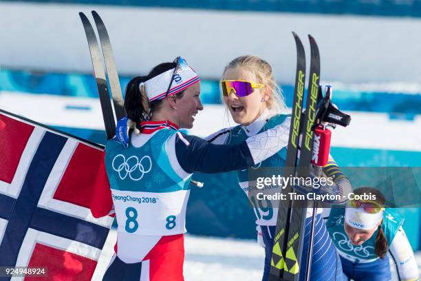 Gold medal winner Marit Bjoergen of Norway congratulates bronze medal winner Stina Nilsson from Sweden during the Cross-Country Skiing - Ladies' 30km...