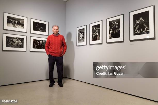 Photographer Chris Steele-Perkins poses next to his work in the exhibition space before Another Kind of Life: Photography on the Margins Installation...