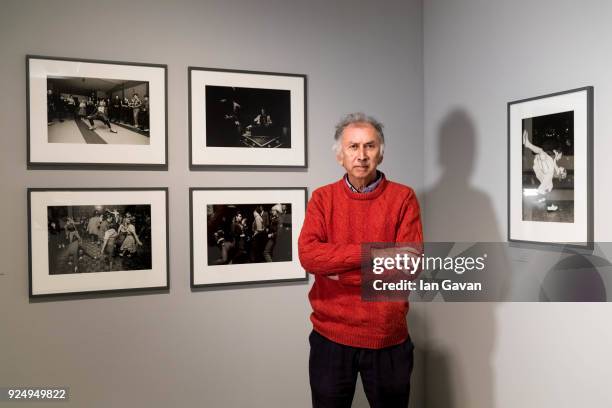 Photographer Chris Steele-Perkins poses next to his work in the exhibition space before Another Kind of Life: Photography on the Margins Installation...