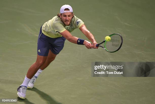 Lucas Pouille of France plays a backhand during his match against Ernests Gulbis of Latvia on day two of the ATP Dubai Duty Free Tennis Championships...