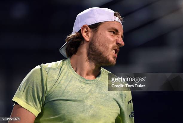 Lucas Pouille of France reacts during his match against Ernests Gulbis of Latvia on day two of the ATP Dubai Duty Free Tennis Championships at the...