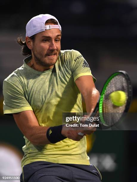 Lucas Pouille of France plays a backhand during his match against Ernests Gulbis of Latvia on day two of the ATP Dubai Duty Free Tennis Championships...