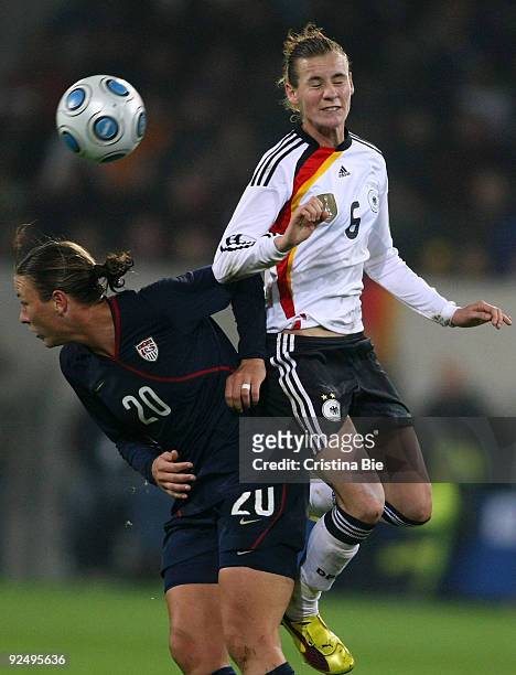 Simone Laudehr of Germany and Abby Wambach of USA jump for a header during the Women's International friendly match between Germany and USA at the...