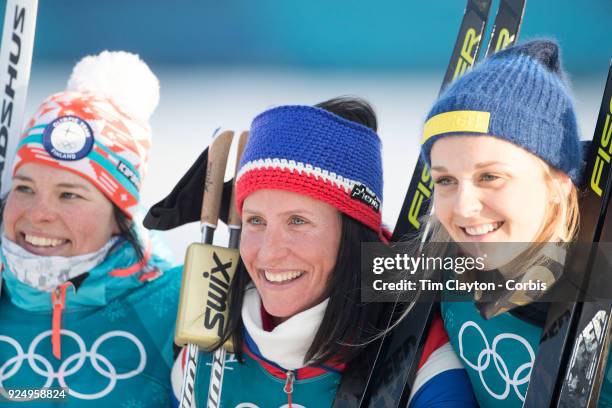 Gold medal winner Marit Bjoergen of Norway, silver medal winner Krista Parmakoski from Finland and bronze medal winner Stina Nilsson from Sweden at...