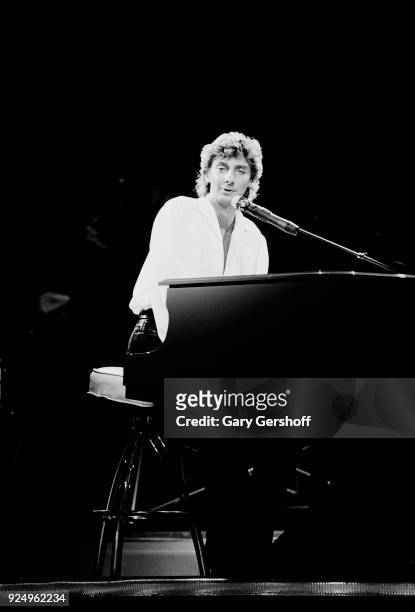 American Jazz and Pop musician Barry Manilow plays piano as he performs onstage at Radio City Music Hall , New York, New York, October 30 1984.