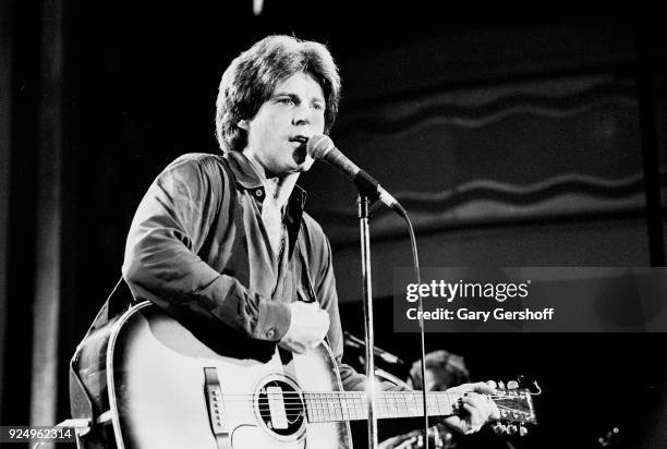 American Rock musician Ricky Nelson plays acoustic guitar as he performs onstage at the Ritz, New York, New York, February 24, 1981.