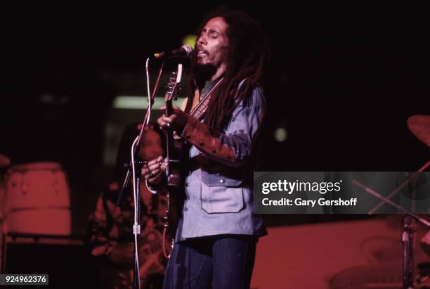 Jamaican Reggae musician Bob Marley plays guitar as he leads his band the Wailers during a performance in the 'Uprising' tour at Madison Square...