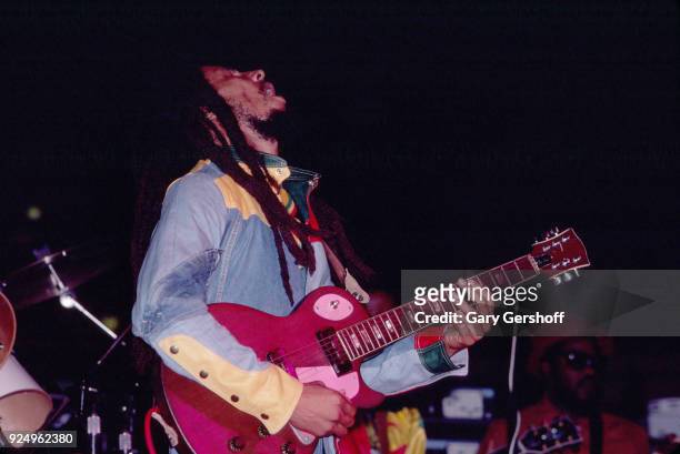 Jamaican Reggae musician Bob Marley plays guitar as he leads his band the Wailers during a performance in the 'Uprising' tour at Madison Square...