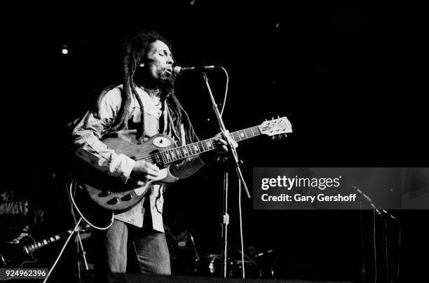 Jamaican Reggae musician Bob Marley plays guitar as he leads his band the Wailers during a performance in the 'Uprising' tour at Madison Square...