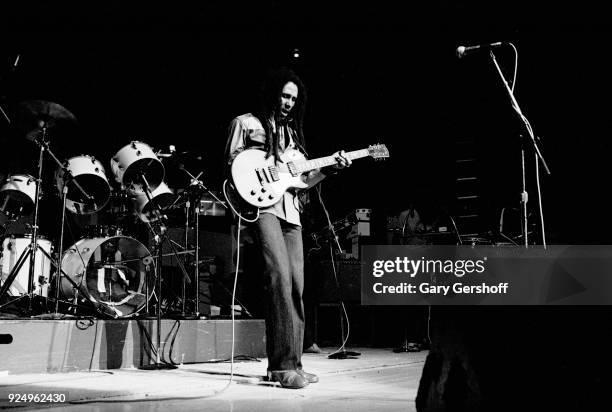 Jamaican Reggae musician Bob Marley plays guitar as he leads his band the Wailers during a performance in the 'Uprising' tour at Madison Square...