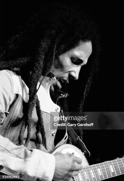 Jamaican Reggae musician Bob Marley plays guitar as he leads his band the Wailers during a performance in the 'Uprising' tour at Madison Square...