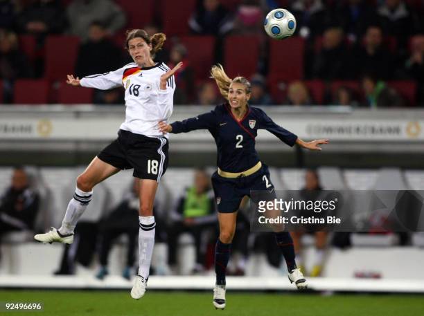Kerstin Garefrekes of Germany and Heather Mitts of USA jump for a header during the Women's International friendly match between Germany and USA at...