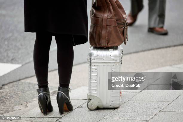 woman carry aluminum suitcase and leather bag - strumpbyxor bildbanksfoton och bilder