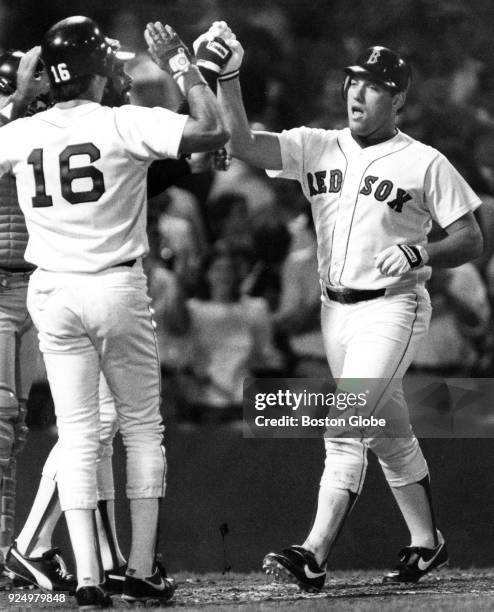 Boston Red Sox Bill Buckner and Mike Easler congratulate Rich Gedman after he scored a home run during a game against the Detroit Tigers at Fenway...