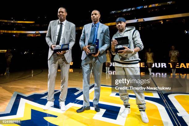 Marcus Camby, Kenyon Martin and Allen Iverson display commemorative gifts awarded to them during the Denver Nuggets "2000's Night" ceremony at Pepsi...