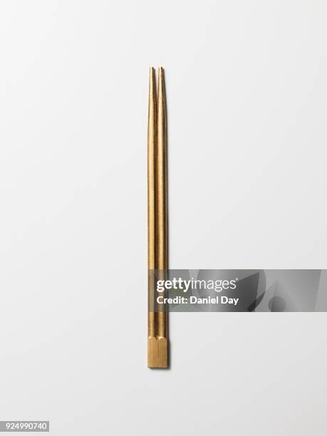 series of every day objects made gold, golden chopsticks against a white background - stäbchen stock-fotos und bilder
