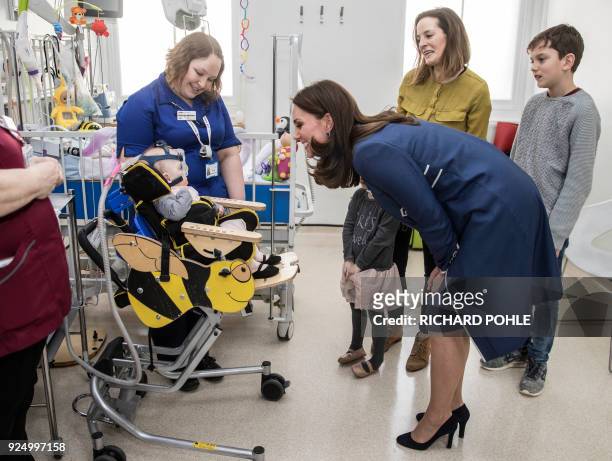 Britain's Catherine, Duchess of Cambridge, meets ten month old Amara Kedwell- Parsons who was born prematurely and is a patient on the children's...