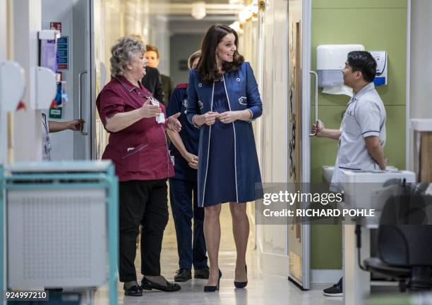 Britain's Catherine, Duchess of Cambridge, arrives at the children's "Snow leopard" ward with director of nursing Janet Powell during a visit to St...