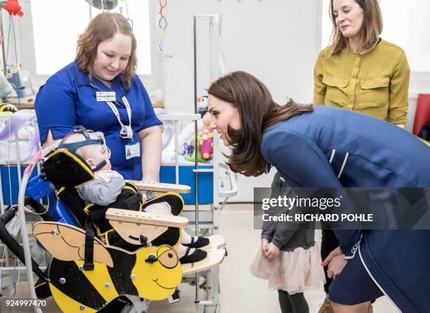 Britain's Catherine, Duchess of Cambridge, meets ten month old Amara Kedwell- Parsons who was born prematurely and is a patient on the children's...