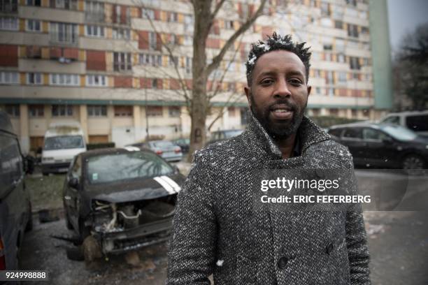 French director Ladj Ly poses under the snow on February 27, 2018 during a portrait session in the "Chene Pointu" council estate in Clichy-sous-Bois,...