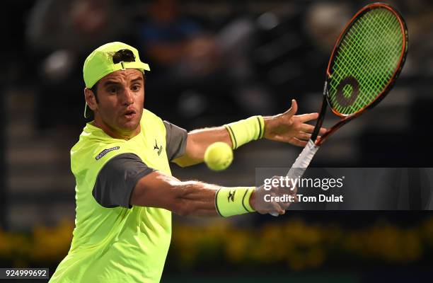 Malek Jaziri of Tunisia plays a backhand against Grigor Dimitrov of Bulgaria on day two of the ATP Dubai Duty Free Tennis Championships at the Dubai...