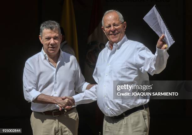 Colombian President Juan Manuel Santos shakes hands with his Peruvian counterpart Pedro Pablo Kuczynski during the 4th Colombia-Peru Binational...