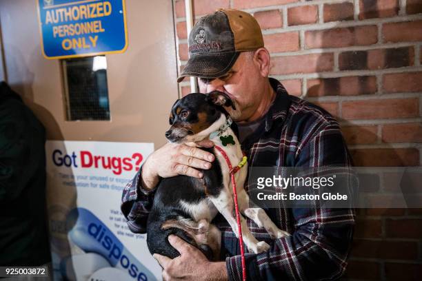 Truck driver Theron Miller kisses his 14-month-old dog Tedge after he was returned to him by Everett Police's animal control officer Stacia Gorgone...